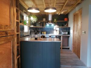 a kitchen with a blue island in a room at Stone Moor Lodge Justin's Peak District Base Camp in Sheffield
