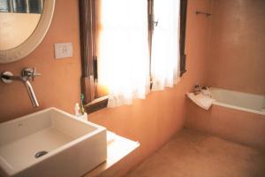 a bathroom with a sink and a tub and a mirror at La Casona in La Plata