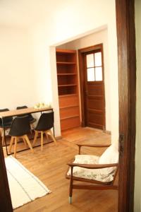a living room with a table and a chair and a table at La Casona in La Plata
