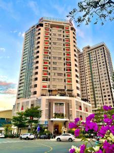 a large building with cars parked in front of it at 2BR Luxury riverview - Melody of the Sea Monarchy in Da Nang