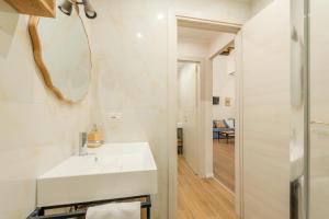 a bathroom with a white sink and a mirror at Pantheon Apartments - Piccola Roma in Rome +53 photos