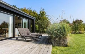 a wooden deck with a bench on the side of a house at 3 Bedroom Amazing Home In Sydals in Sarup +18 photos