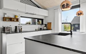 a white kitchen with a sink and a window at 3 Bedroom Amazing Home In Sydals in Sarup