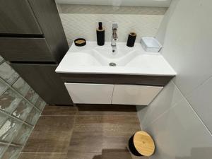 a bathroom sink with two bottles on top of it at La Villa Grenade in Pointe-Noire +8 photos