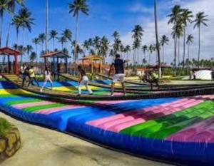 a group of people playing in a water park at Villa Vacacionales Los Cayos Con Playa Privada in Boca de Aroa