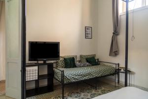 a living room with a couch and a tv at La casa di Nina in Monte di Procida