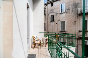 a balcony with a table and chairs on a building at La casa di Nina in Monte di Procida
