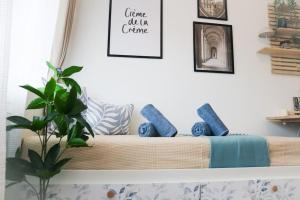 a living room with a couch with blue pillows at Le Petit- Niedliches Ferienapartment mit Pool in Schluchsee +29 photos