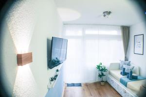 a living room with a couch and a large window at Le Petit- Niedliches Ferienapartment mit Pool in Schluchsee