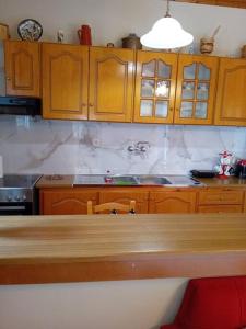 a kitchen with wooden cabinets and a counter top at Mountain View in Feneos +6 photos