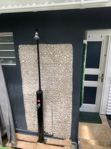 a baseball bat on a wall next to a door at Studio DREAM avec petit déjeuner in Pointe-Noire