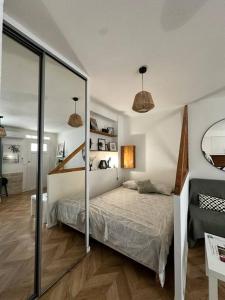a bedroom with a bed and a sliding glass door at Appartement cosy jardin et clim in Sète