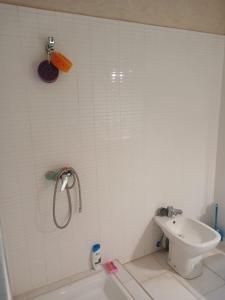 a white bathroom with a shower and a sink at Villa Lmima Malika in Marrakech