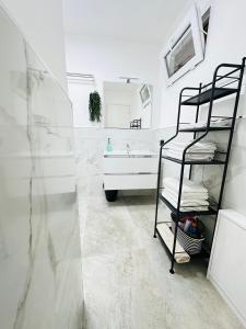 a bathroom with a sink and a towel rack at Siloe Apartment Palermo in Palermo