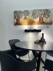 アテネにあるEstia Athens Apartmentの壁画のある部屋内のテーブルと椅子