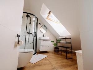 a bathroom with a shower and a toilet and a sink at Widokowy 2 in Sandomierz