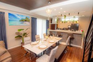 uma sala de jantar com mesa e cadeiras em umikaze 2024年10月Open 新築物件 em Uruma