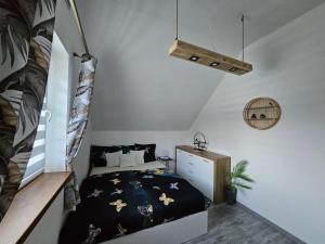 a small bedroom with a bed and a staircase at Spokojny zakątek in Ustroń