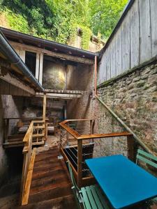 a room with stairs and a blue table in a building at Maison avec garage et terrasse quartier historique in Épinal