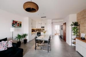 a living room and kitchen with a table and a couch at Widokowy 1 in Sandomierz