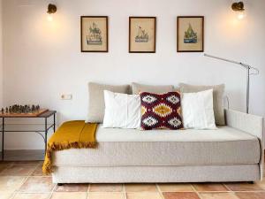 Un dormitorio con una cama con almohadas encima. en Casa Moll. Tradición y bonitas vistas de Alicante, en Alicante