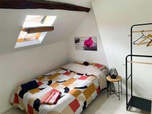 a bedroom with a bed and two skylights at La perle rare Chambly, Proche Parc Astérix , château de Chantilly in Chambly