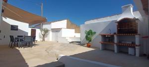 a patio with a table and chairs in a building at Casa da Pedra in Pedrógão