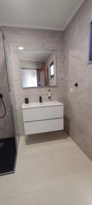 a bathroom with a sink and a mirror at Casa da Pedra in Pedrógão