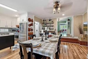 a kitchen and dining room with a table and chairs at 1930s Queen Anne Historic Downtown Retreat in Medford