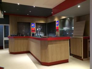 a restaurant with a counter in a room at Sunny Days Hotel in Blackpool