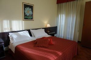 a bedroom with a large bed with a red blanket at Hotel Europa in Palermo