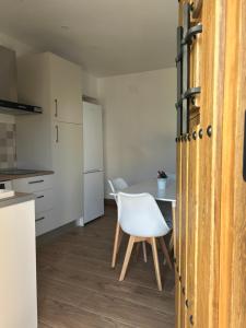 a kitchen with a table and a white chair at La Casita de Josefa in Zahara de la Sierra