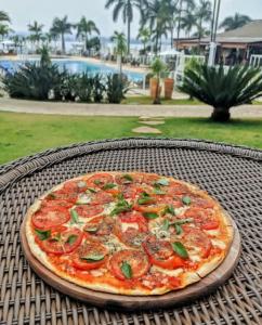 a pizza sitting on top of a table at Apartamento Life Resort Brasília in Brasilia