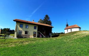 a house on top of a hill with a tower at appartement de campagne seul in Ursy