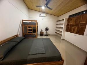 a bedroom with a bed and a ceiling fan at Cabaña OtraParte in Rincón
