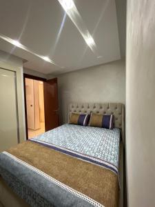a bedroom with a bed with two pillows on it at Mini Villa 2 Al hoceima in Al Hoceïma +15 photos