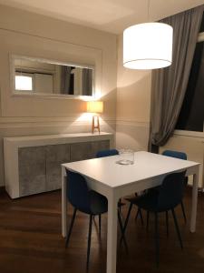 a dining room with a white table and chairs at Bologna's Heart at Farini 31 in Bologna