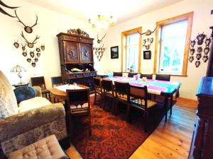 a living room with a dining room table and chairs at Unik Villa Brunnen Blick mit offenem Dachstuhl in Sankt Andreasberg