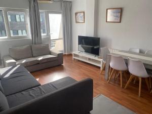 a living room with a couch and a table at Apartamento Plaza Pradollano 1 in Sierra Nevada