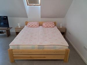 a bedroom with a bed with two pillows on it at Atkacs Home in Győr
