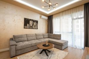 a living room with a couch and a table at Belgrade Waterfront SCALA in Belgrade