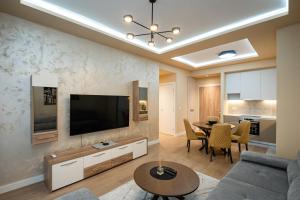 a living room with a couch and a table at Belgrade Waterfront SCALA in Belgrade
