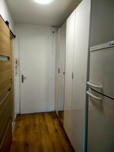 an empty room with white walls and a refrigerator at Charmant studio in Roissy-en-France