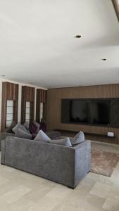 a living room with a couch and a flat screen tv at Marina casablanca in Casablanca +21 photos