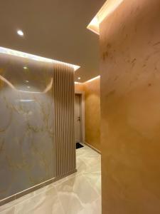 a hallway with a marble wall in a building at Apartments Zejak in Mitrovići