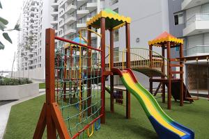a playground with a slide in a building at Lima Flats 2 in Lima
