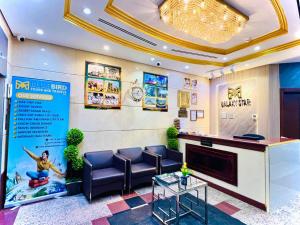 a lobby with a waiting room with chairs and a tv at Galaxy Star Hotel in Dubai