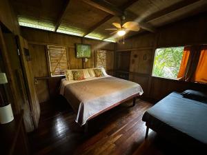 a bedroom with a bed in a wooden room at Casa Rio Blanco Eco Friendly B&B in Guápiles