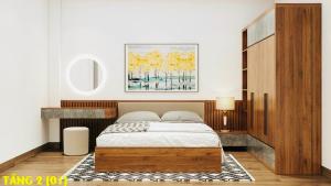 a bedroom with a bed and a painting on the wall at An HOSTEL in Ninh Binh