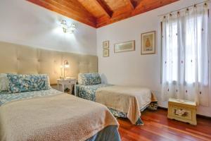 una camera da letto con due letti e una finestra di Villa Charly a Puerto de la Madera